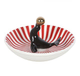 Circus style quirky trinket dish featuring a black circus seal balancing a golden ball gothic alternative twisted circus range